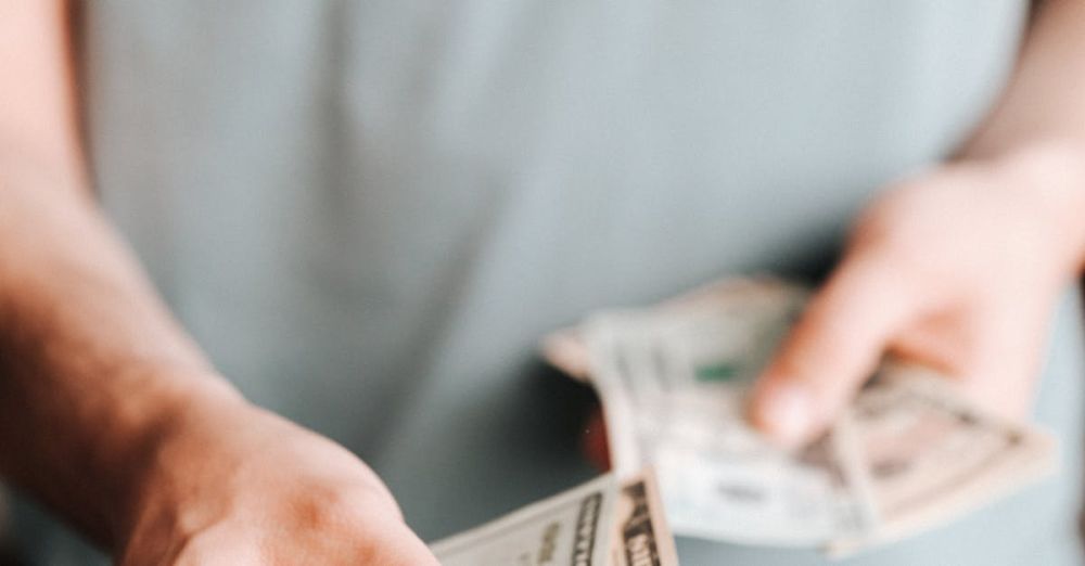 Expenses - Crop man paying with American dollars