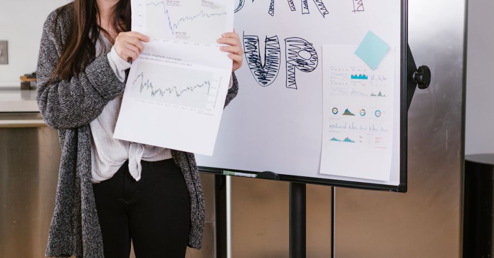 Tech Startups - Woman in Gray Coat Holding White Printer Paper