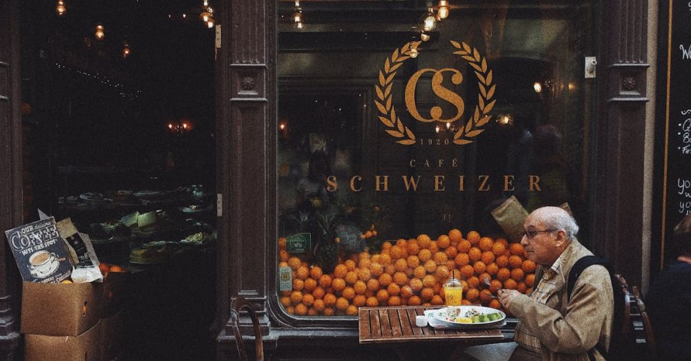 Consumer Behavior - Man in Brown Jacket Sitting on Chair in Front of Fruit Stand