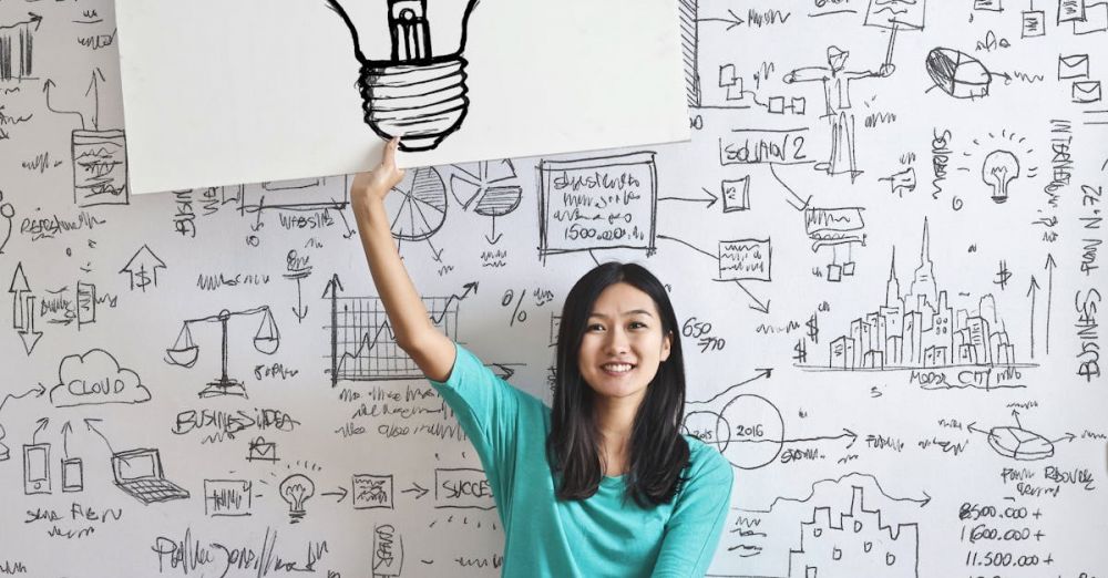 Strategy - Woman Draw a Light bulb in White Board