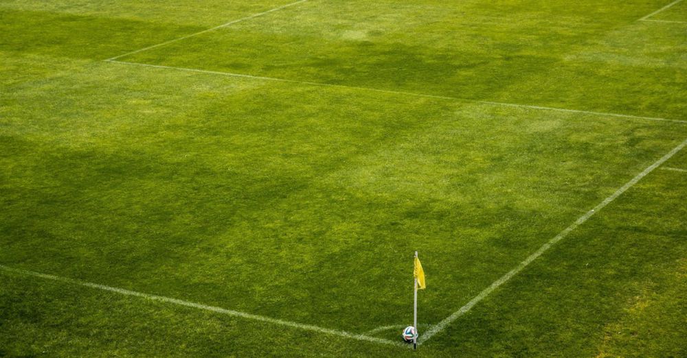 Pitch - White and Black Soccer Ball on Side of Green Grass Field during Daytime